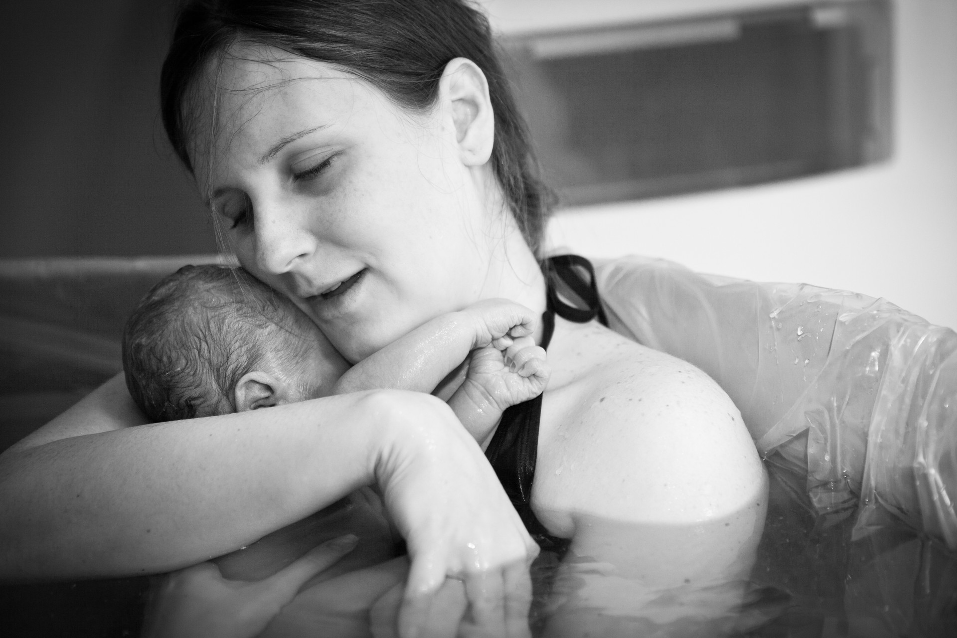 Mother Embracing Her Newborn after Home Water Birth